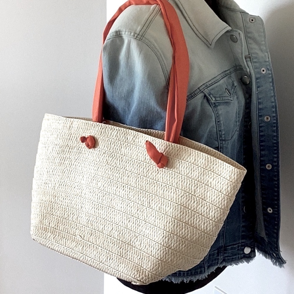 Cream colored straw tote, beach bag with coral fabric straps